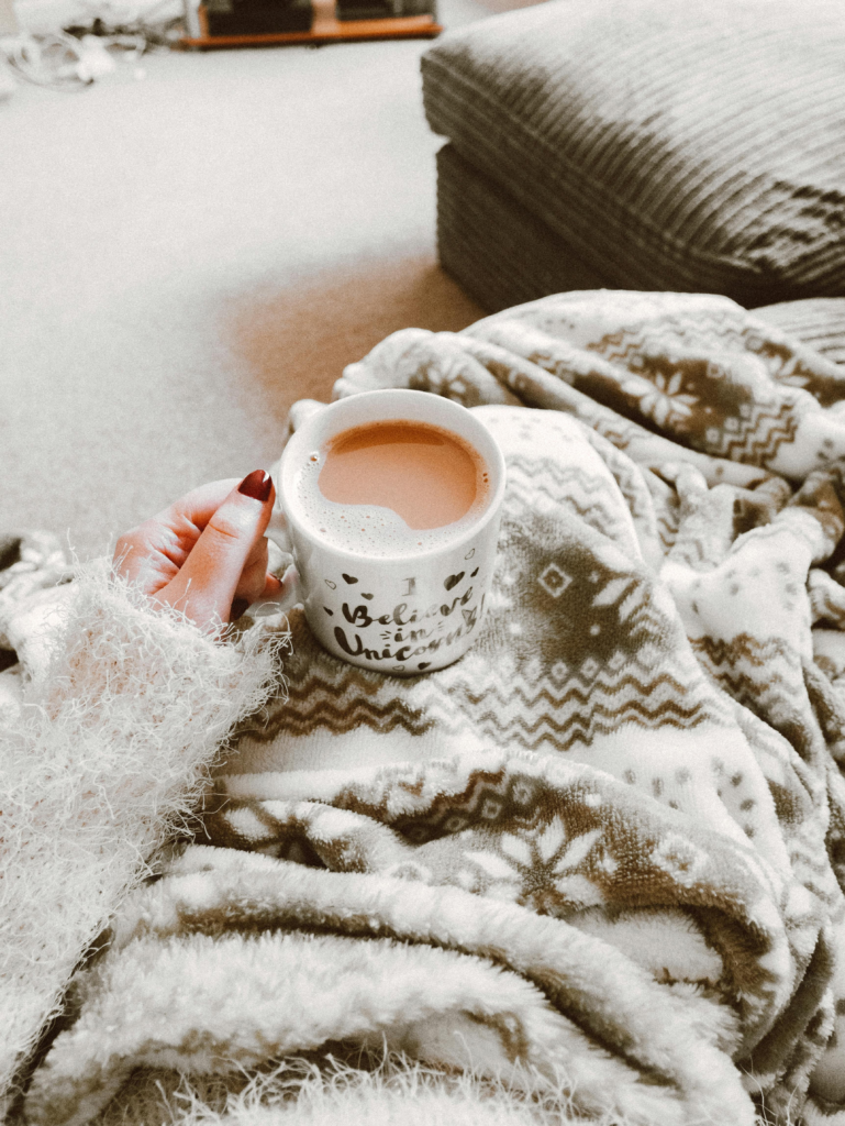 Cozy scene with a warm drink and blanket representing sensory-friendly gifts for people with ADHD